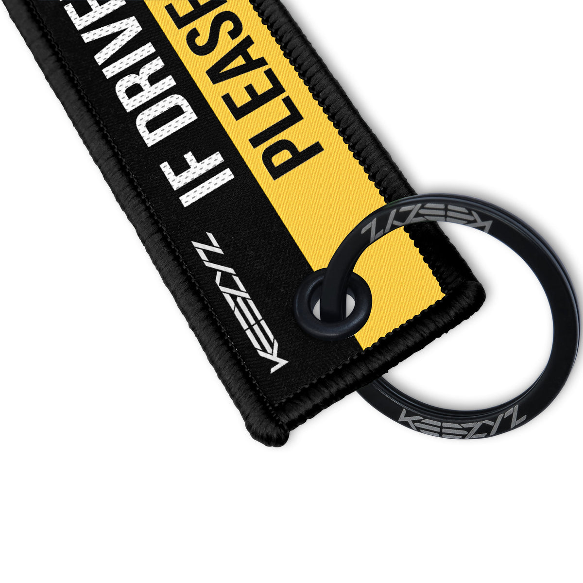 Close-up of the Keezyz If Driven Carefully Please Report Stolen keychain with Black border