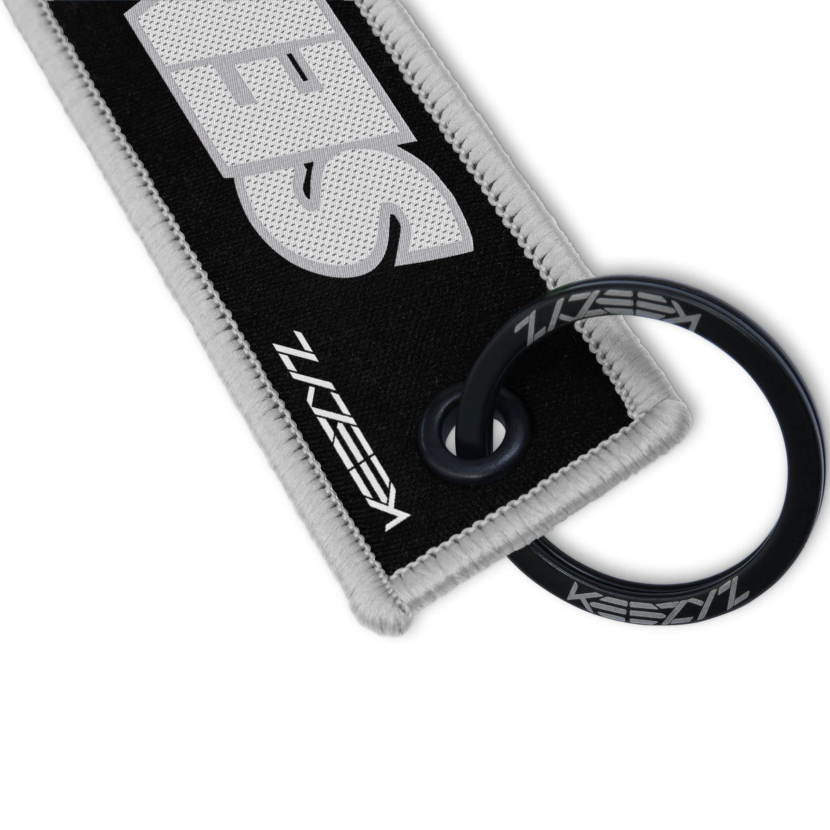 Close-up of the Keezyz Send It keychain with Gray border